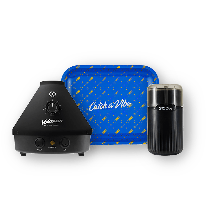 Volcano Classic Onyx vaporizer shown with vibrant blue tray in winter-themed setting