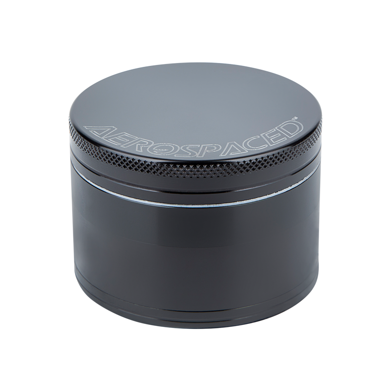 Aerospaced 4-piece aluminum herb grinder with magnetic lid and kief catcher in use