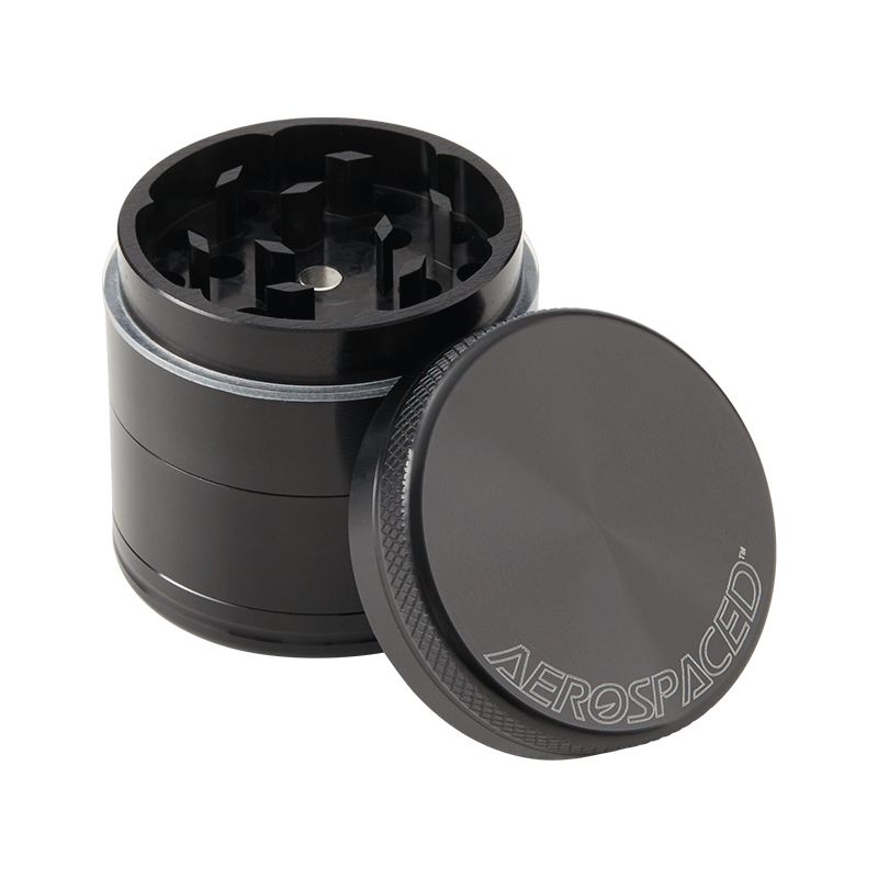 Aerospaced 4-piece aluminum herb grinder with magnetic lid and kief catcher in use