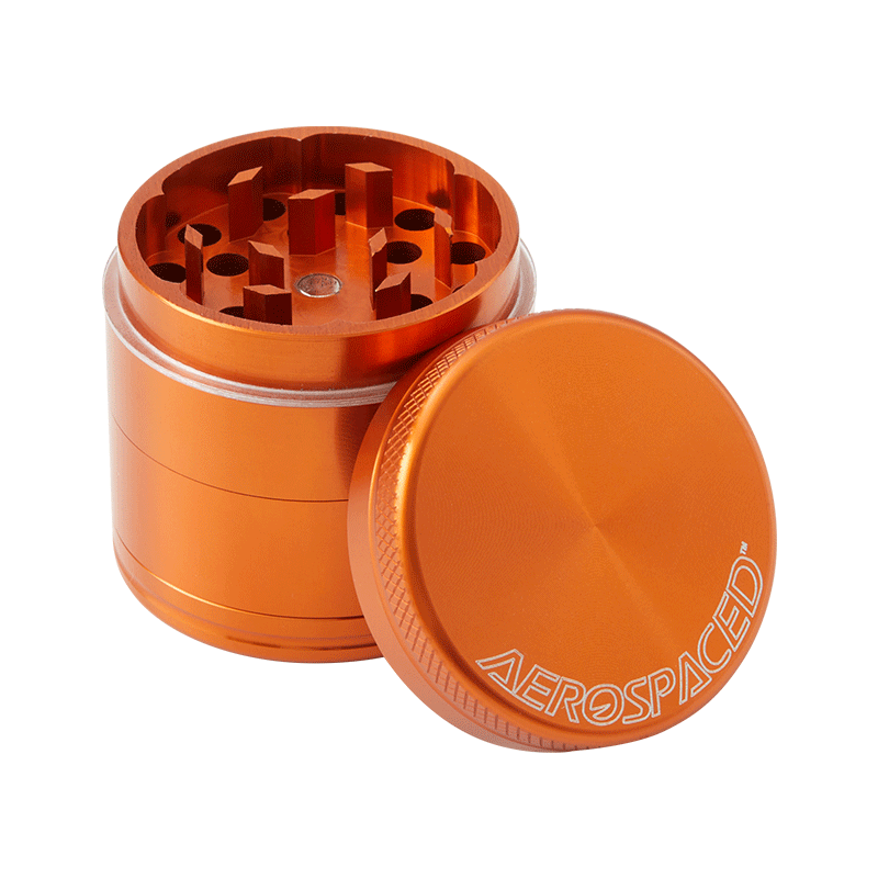 Aerospaced 4-piece aluminum herb grinder with magnetic lid and kief catcher in use