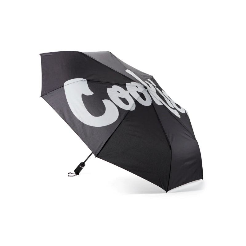 Cookies umbrella with mint logo opened during rain, showcasing its stylish design