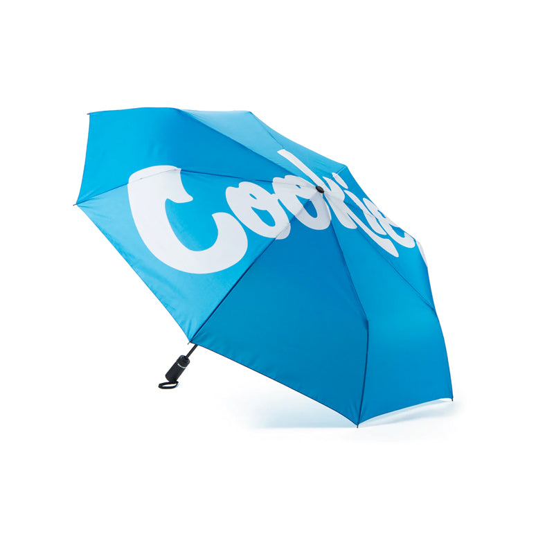 Cookies umbrella with mint logo opened during rain, showcasing its stylish design
