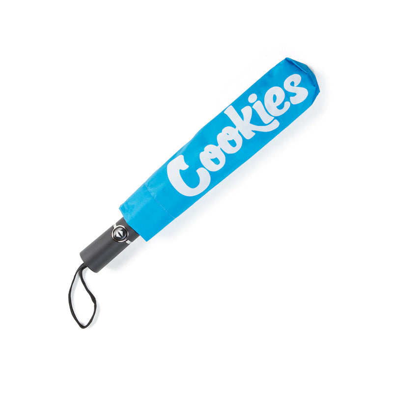 Cookies umbrella with mint logo opened during rain, showcasing its stylish design