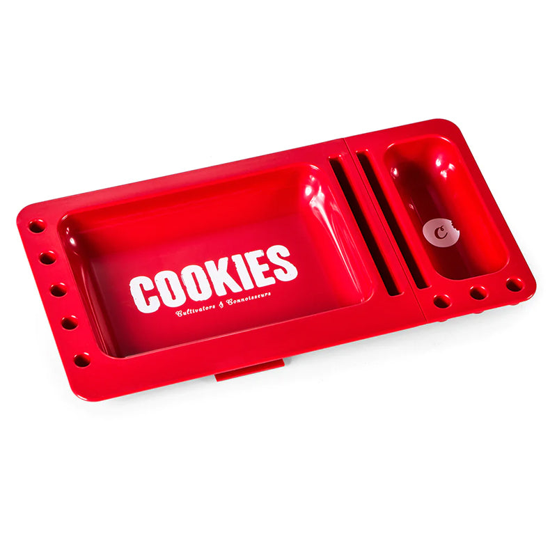 User placing rolling paper and herb on the portable tray for quick roll-up