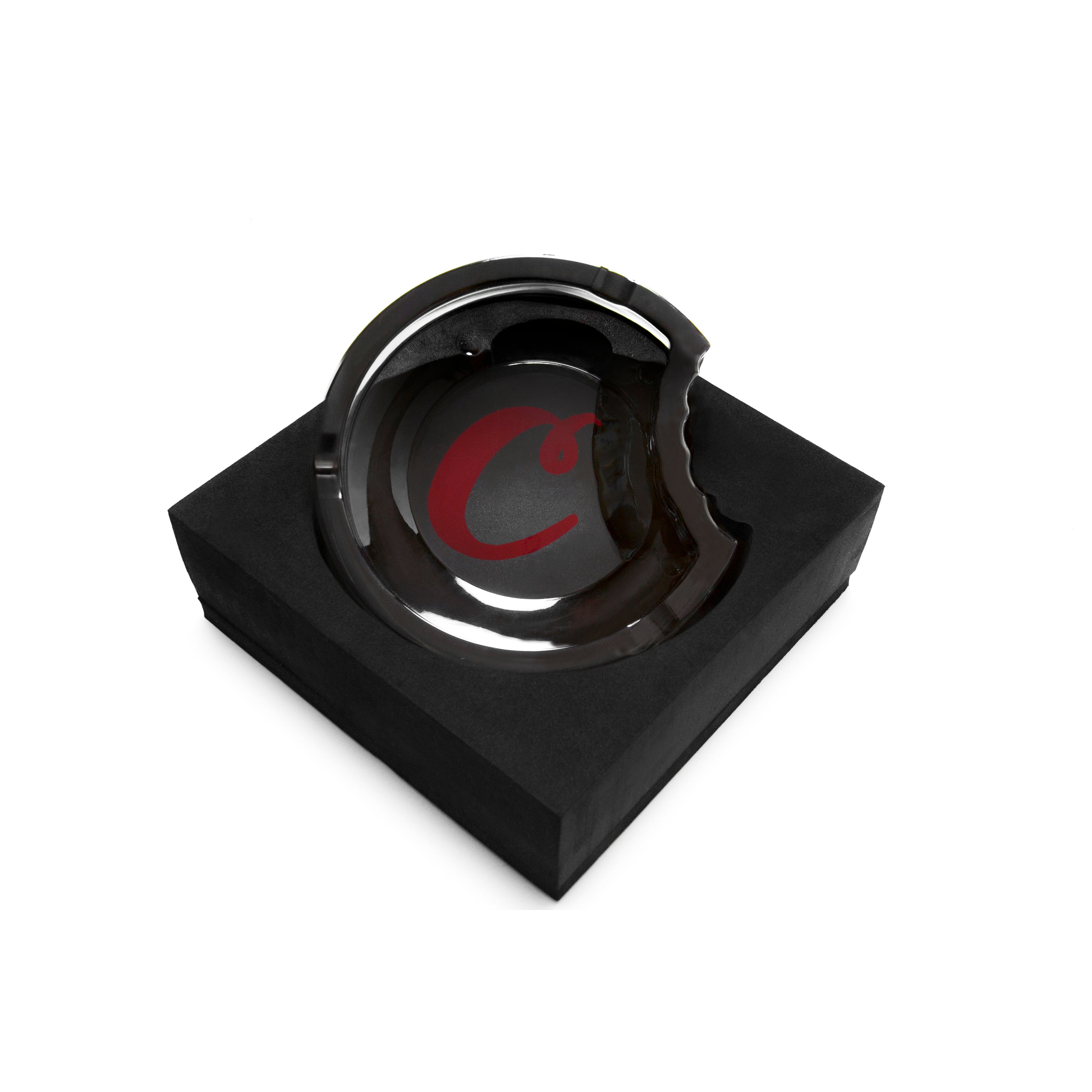 Side profile of the glass ashtray revealing its thick, heat-resistant structure and branding