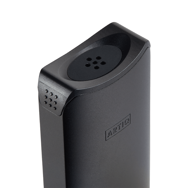 User  holding the DaVinci ARTIQ portable vaporizer in a casual setting, illustrating its on-the-go convenience.