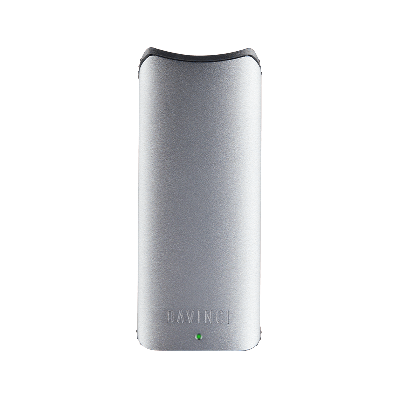 User  holding the DaVinci ARTIQ portable vaporizer in a casual setting, illustrating its on-the-go convenience.