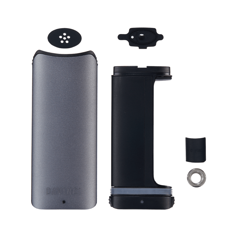 User  holding the DaVinci ARTIQ portable vaporizer in a casual setting, illustrating its on-the-go convenience.
