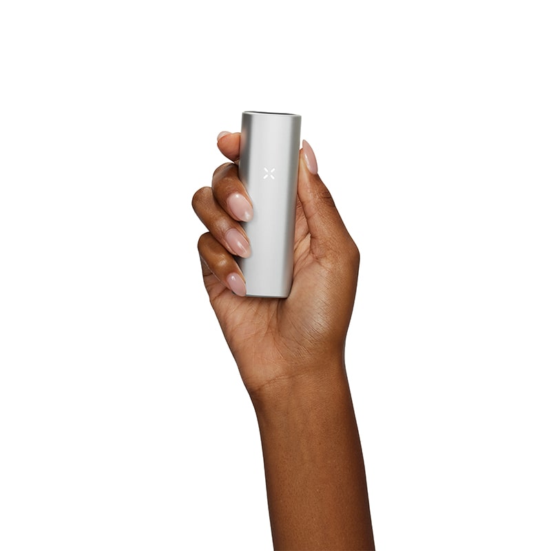 PAX Mini vaporizer in hand, showcasing its discreet design for on-the-go use.