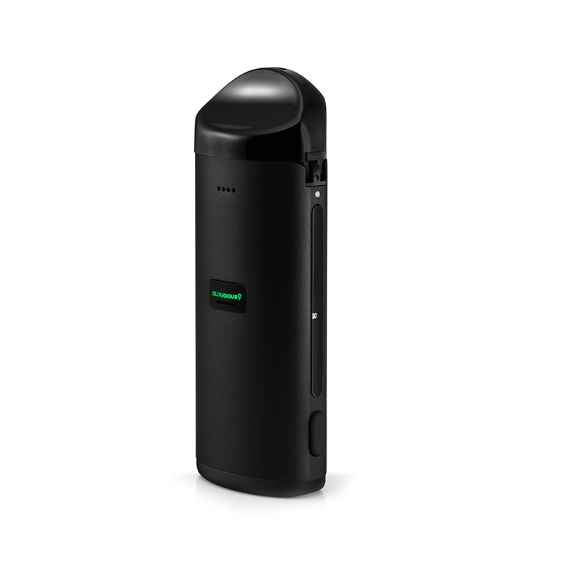 User filling dry herbs into the Atomic9 vaporizer with herb scoop
