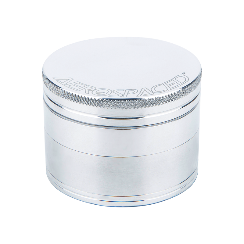 Top view of the aluminum herb grinder showcasing razor-sharp teeth and mesh sifter
