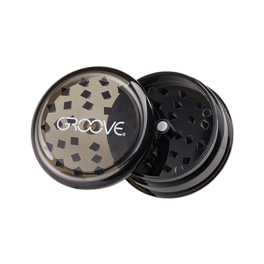 Close-up of Groove Acrylic Herb Grinder showing the grinding teeth and transparent body
