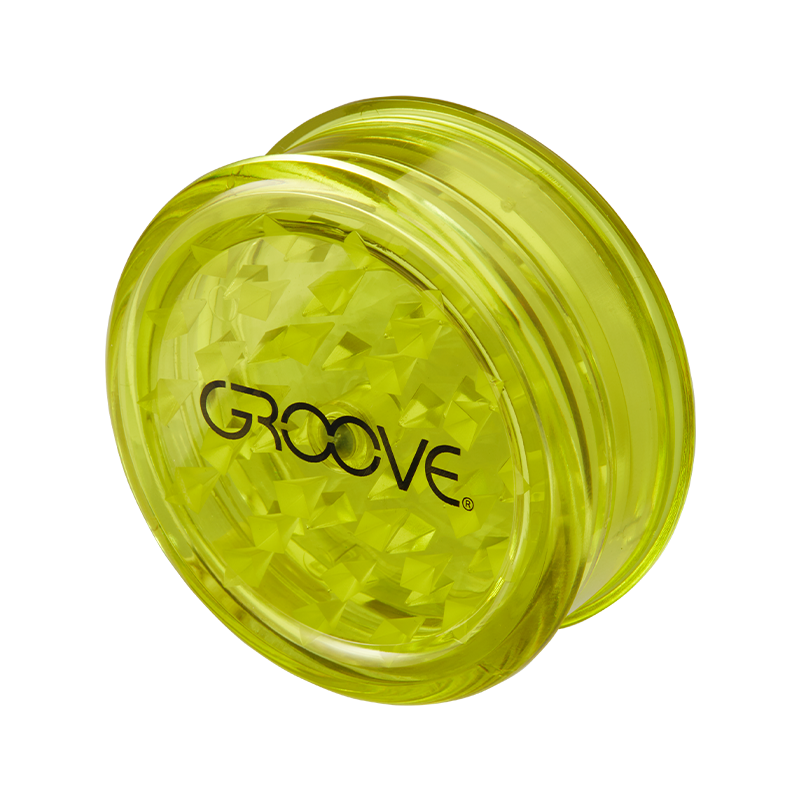Close-up of Groove Acrylic Herb Grinder showing the grinding teeth and transparent body