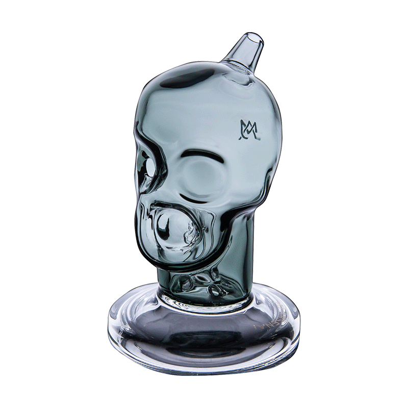 Close-up of the skull-shaped glass bubbler with intricate design for dry herbs