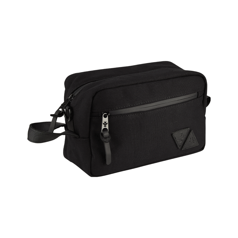 Stowaway Luxe Luggage showcasing its sleek black exterior and leather patches, perfect for stylish travel.
