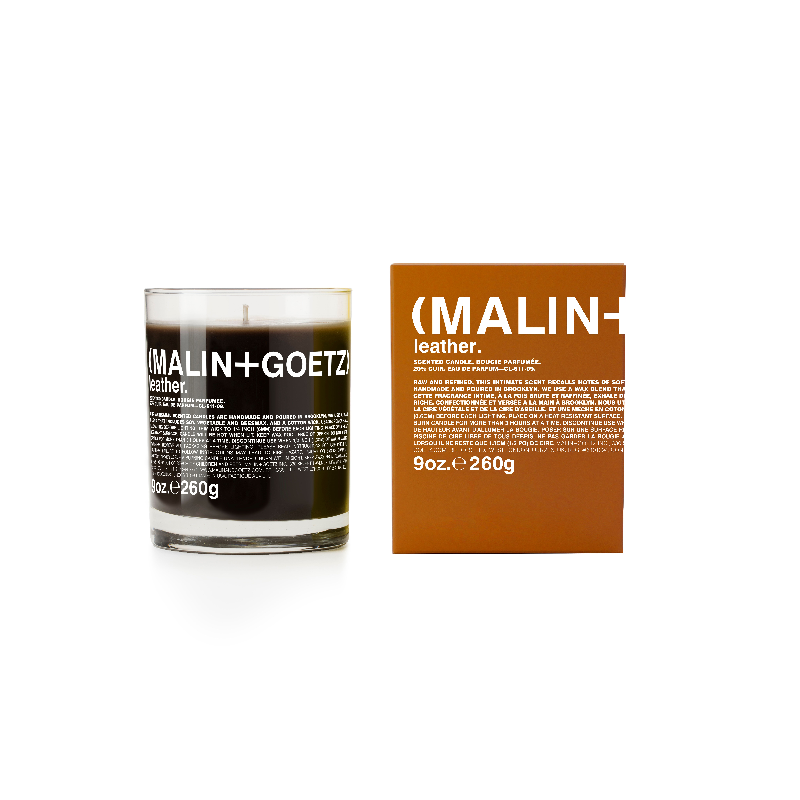Luxurious MALIN + GOETZ leather candle on a stylish shelf, showcasing its modern design.
