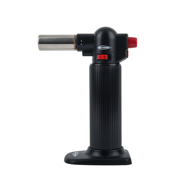 Close-up of Blazer Big Buddy Turbo Torch with flame lit, showing high-temperature flame for industrial welding