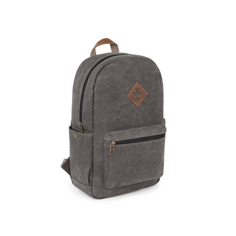 Outdoor traveler using Revelry Escort waterproof backpack in rainy conditions