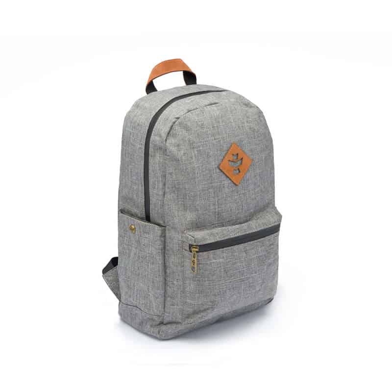 Outdoor traveler using Revelry Escort waterproof backpack in rainy conditions